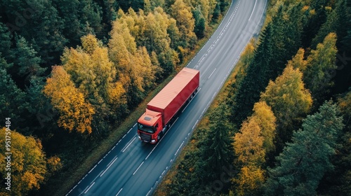 Red Semi Truck on Winding Road Through Autumn Forest