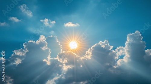 bright sun shining through fluffy clouds in serene clear blue sky scene