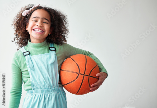 Kid, girl and happy with basketball in white background with sports for training and fitness in Brazil. Female person, portrait and smile or excited with hobby on mockup space for child development photo