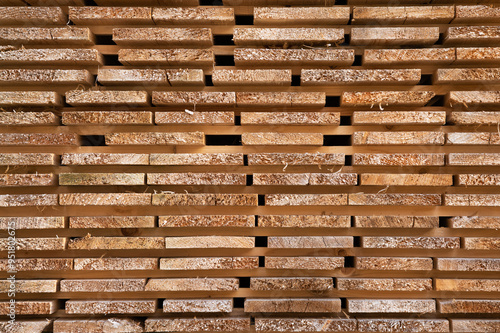 Studs in a lumber yard featuring the wood grain, stacked block board