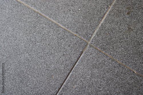 Obraz na płótnie Close-up of gray textured floor tiles with grout lines.