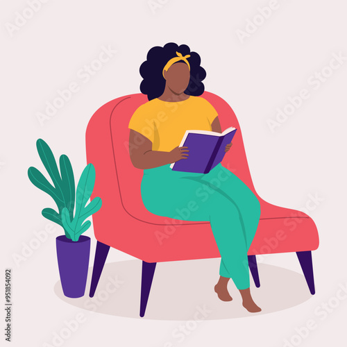 One Curvy Black Woman Sitting On Couch And Reading A Book At Home.
