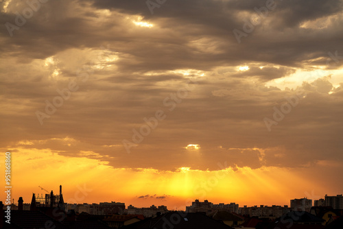 Sunset over city. Evening city landscape. Sunset over multi-story buildings. Cityline with colorful sky. Residential area of the city in evening. Cityscape with summer sunset. Town, metropolis