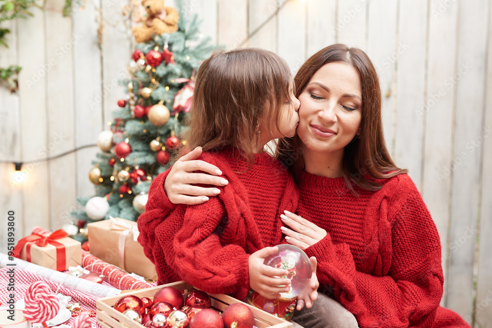 Christmas in July. Family woman mother and child daughter on the background of a Christmas tree
Christmas in July. Family woman mother and child daughter on the background of a Christmas tree