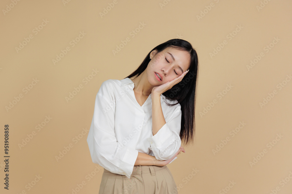 Sleepy Asian Woman Resting Head on Hand with Tired Expression Sleepy Asian Woman Resting Head on Hand with Tired Expression