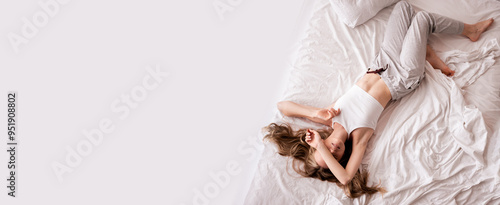 Happy woman sleeping lying on bed in bedroom, morning in the bedroom at home, enjoy weekend and free time, top view #951908802