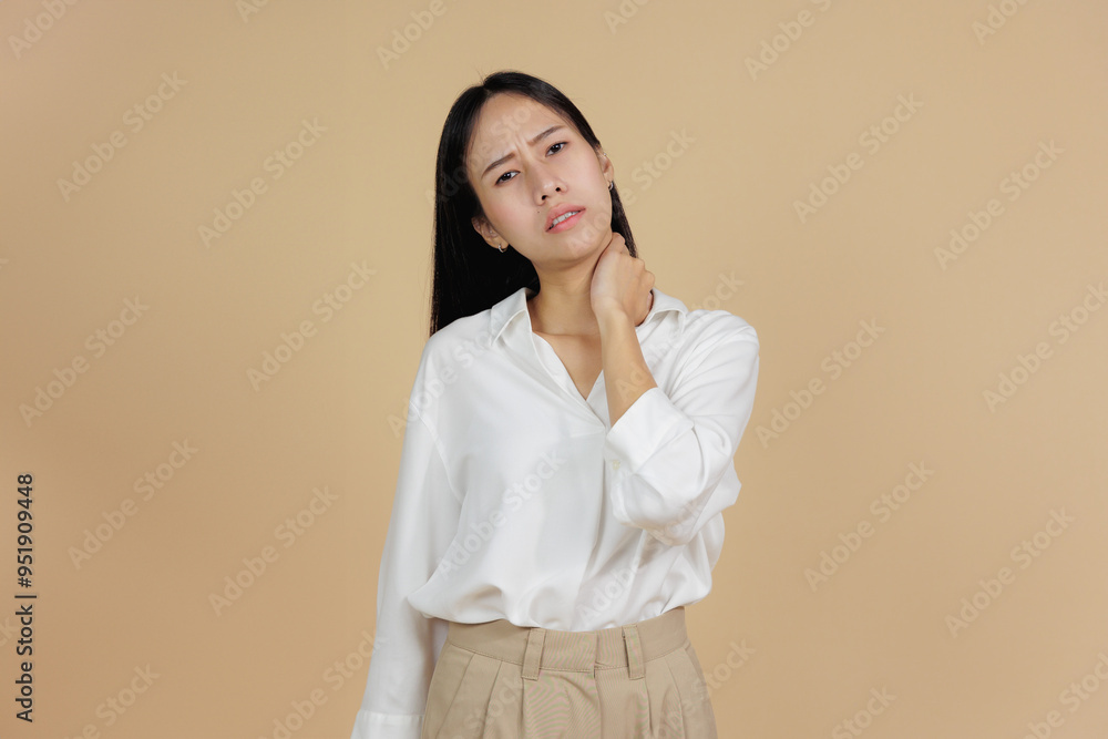 Asian Woman Suffering from Neck Pain, Holding Her Neck in Discomfort Asian Woman Suffering from Neck Pain, Holding Her Neck in Discomfort