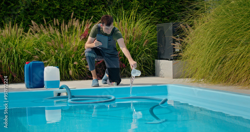 Pool technician pouring liquid into the pool while using a tablet, with chemical containers and greenery in the background.
