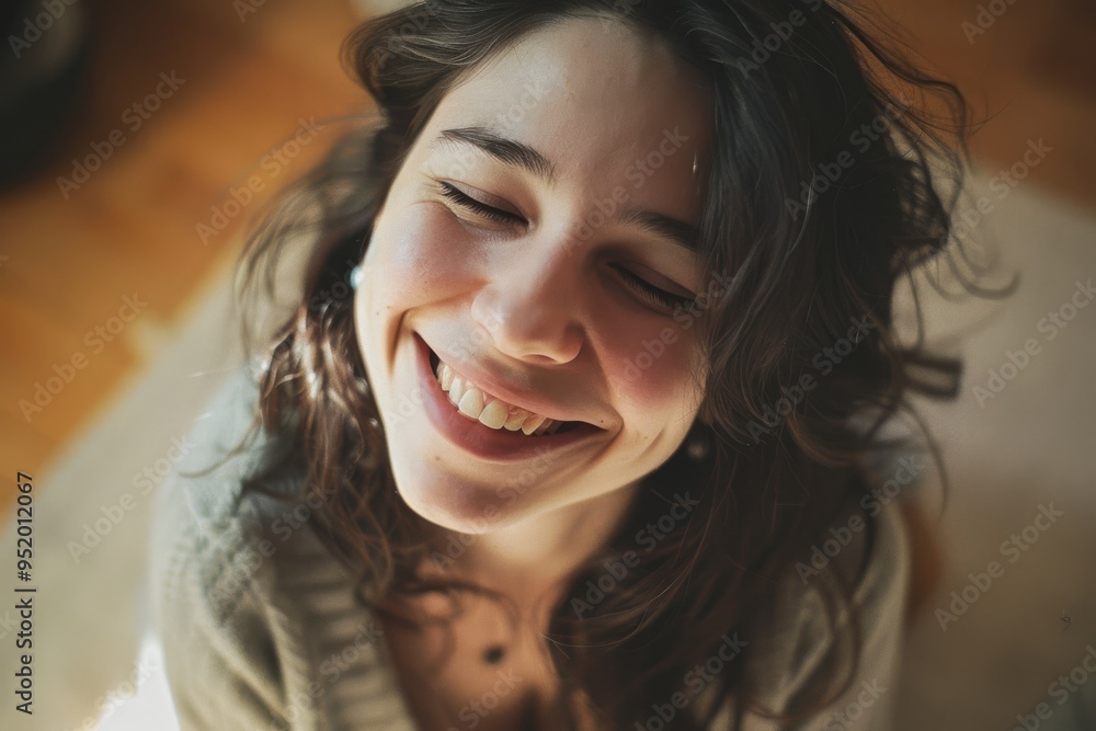 Woman grins joyfully, casting a shadow play on the wall, creating a serene and carefree atmosphere. Woman grins joyfully, casting a shadow play on the wall, creating a serene and carefree atmosphere.