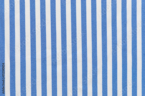 A close-up of a sky blue and white vertical striped linen shirt. Textured, striped background image.