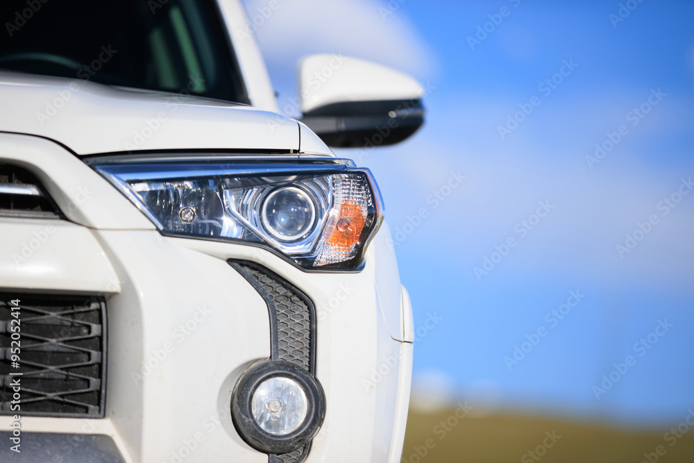 Offroad car on mountain top under blue sky Offroad car on mountain top under blue sky