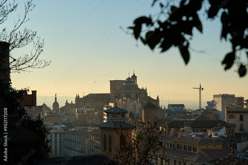 View of houses on hill in Granada, Spain, in sunset View of houses on hill in Granada, Spain, in sunset