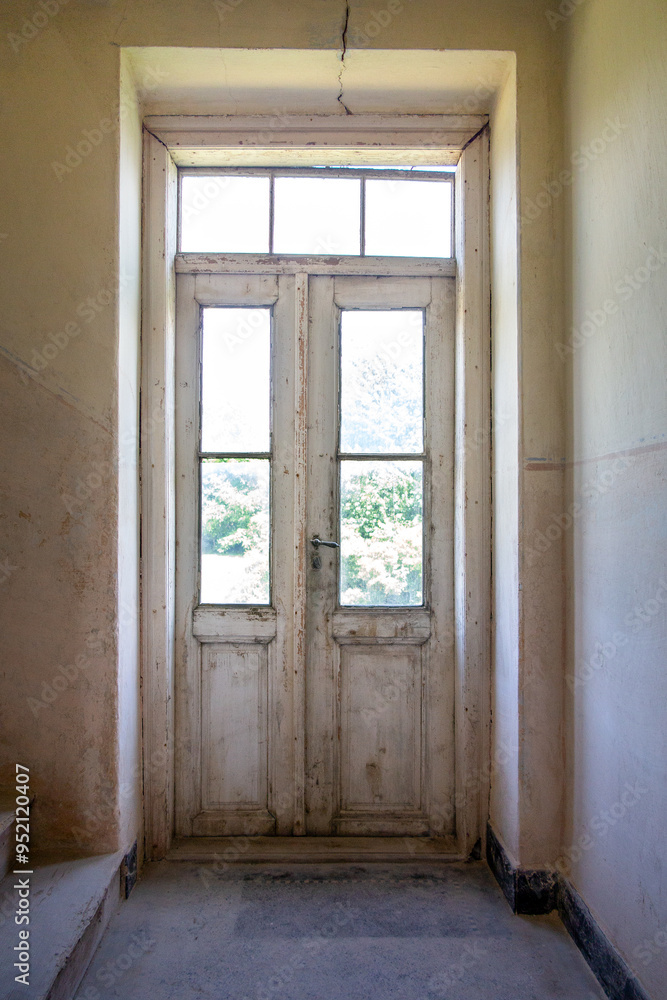 door in an old house, corridor with glass old door, interior view of the glass door to the garden door in an old house, corridor with glass old door, interior view of the glass door to the garden