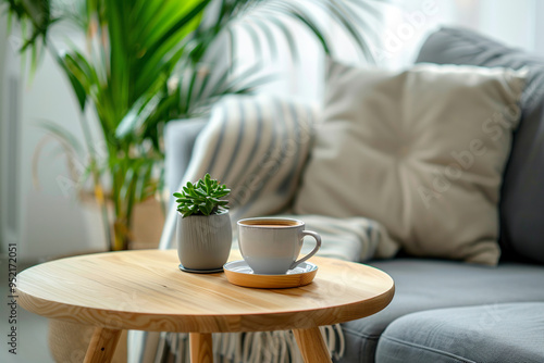 Living room with wooden table with potted plant and cup of freshly brewed coffee