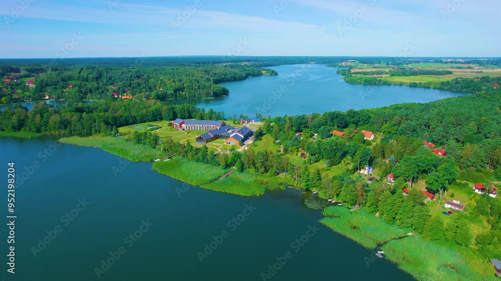 Beautiful Lake With Islands is Surrounded by Trees and Houses. Sky is Clear Sun is Shining. Majestic Aerial View of Calm Lake With Islands in Europe. Village Houses on Shore of Paradise Place Lake. Beautiful Lake With Islands is Surrounded by Trees and Houses. Sky is Clear Sun is Shining. Majestic Aerial View of Calm Lake With Islands in Europe. Village Houses on Shore of Paradise Place Lake.