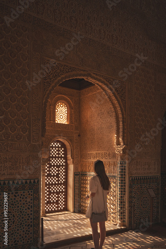 person in a courtyard of the palace of Alhambra in Granada Spain
