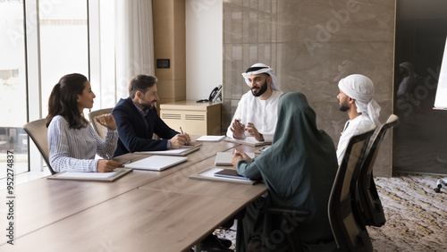 Принти на полотні Happy young Arab business leader man talking to diverse partners at meeting