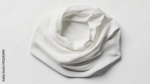 A soft, white infinity scarf elegantly arranged on a light background.