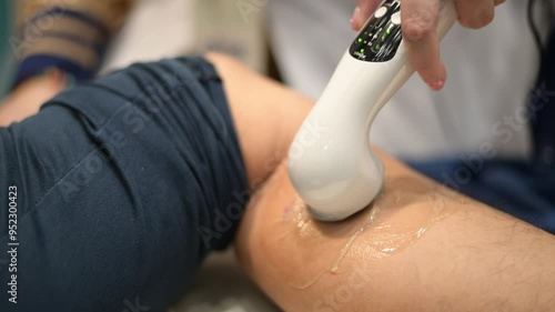 Physical Therapist Applying Ultrasound Therapy to Patient's Leg