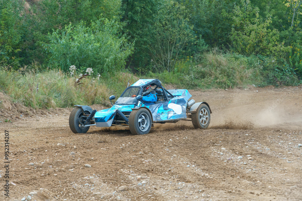 A close-up of an autocross racing car. Clouds of dust and sand burst out from under the wheels. Off-road racing.