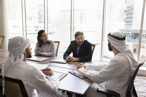 Photography Arab and European business partners discussing collaboration terms, contract, teamwork