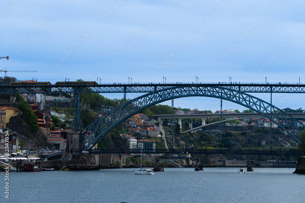 Obraz premium View of Porto city and Douro river and Dom Luis bridge. Porto, Vila Nova de Gaia, Portugal. Cityscape along the river