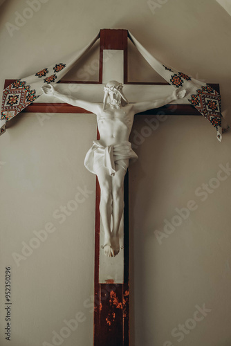 large and exquisite Corpus Christi figure, crafted from fine bisque porcelain, elegantly mounted on a beautifully finished wood cross, adorned with intricately designed embroidery cloth that enhances  photo