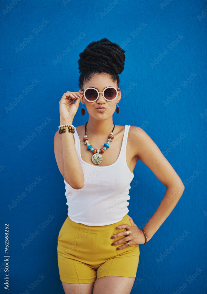 Woman, portrait and sunglasses with fashion for style in summer on a blue wall background. Young female person, gen z model or cool hipster with eyewear, jewelry or stylish accessories for glamour Woman, portrait and sunglasses with fashion for style in summer on a blue wall background. Young female person, gen z model or cool hipster with eyewear, jewelry or stylish accessories for glamour
