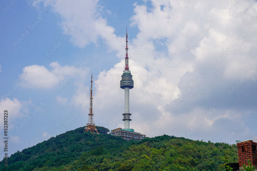 Namsan Tower, a landmark in Seoul, South Korea, with the surrounding cityscape in the background. Namsan Tower, a landmark in Seoul, South Korea, with the surrounding cityscape in the background.
