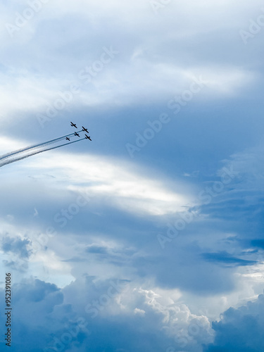 Five airplanes ply in the clouds 