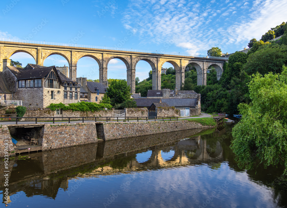 Fototapeta premium Historical viaduct above the Port de Dinan, reflecting in river Rance, Brittany, France