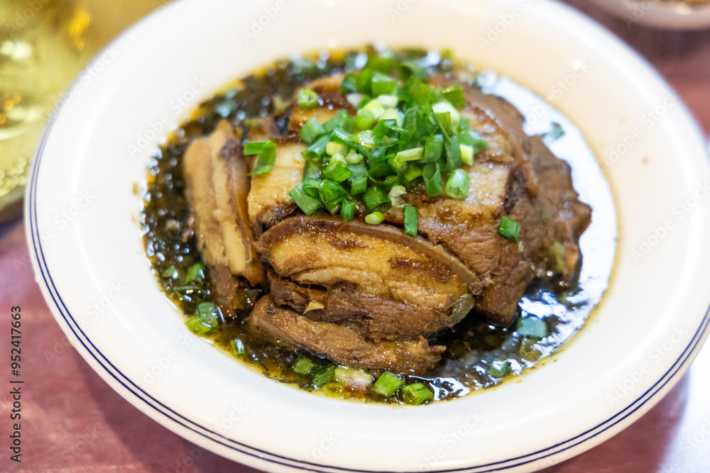 Serving of simple and authentic Sichuan cuisine of sliced pork belly with preserved vegetables topped with scallion Serving of simple and authentic Sichuan cuisine of sliced pork belly with preserved vegetables topped with scallion
