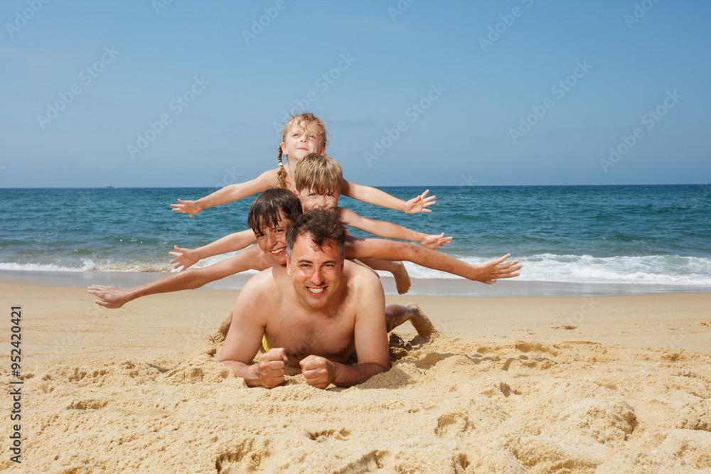 Family enjoy a fun day at the beach with playful sand activities Family enjoy a fun day at the beach with playful sand activities
