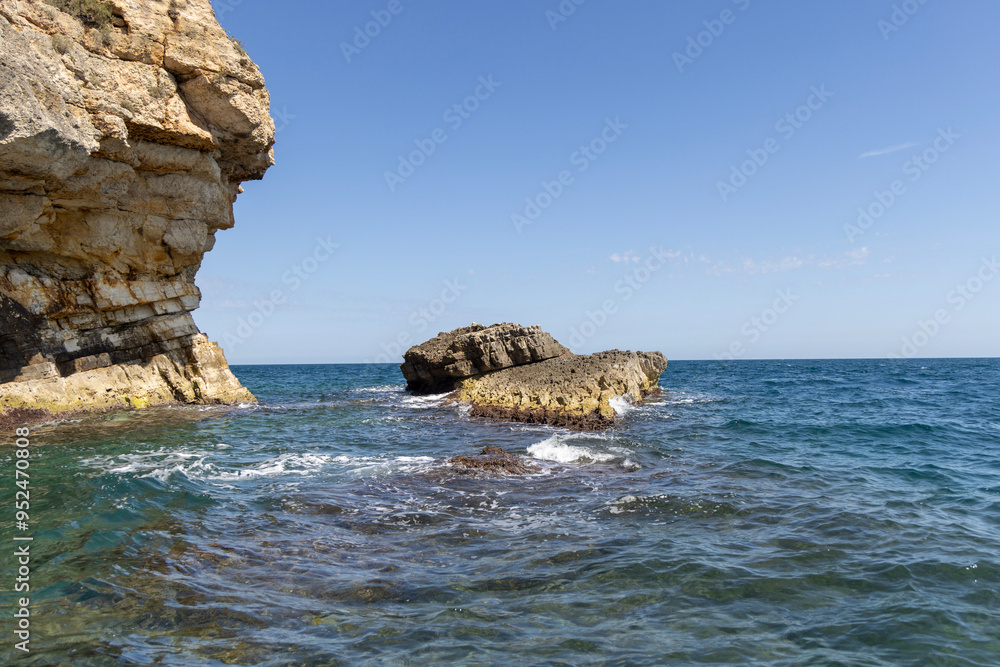 View from the water of picturesque coastline with cliffs and caves by Adriatic Sea, Polignano a Mare, Italy, Apulia
