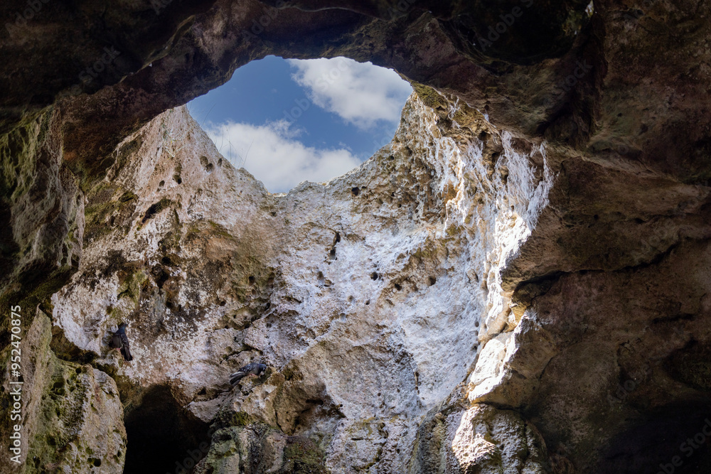 View of the sky from inside the grotto through an opening in the cliff, Polignano a Mare, Italy, Apulia