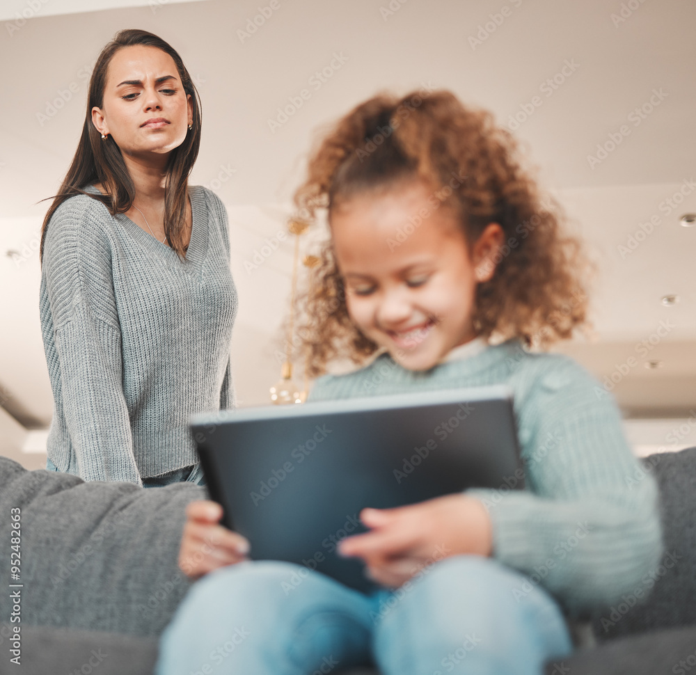 Kid, girl and smile with tablet on couch in home for education games, cartoon and entertainment. Female person, sofa and happy with mom in living room on internet or website for subscription Kid, girl and smile with tablet on couch in home for education games, cartoon and entertainment. Female person, sofa and happy with mom in living room on internet or website for subscription