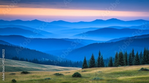 Wallpaper Mural A serene mountain landscape at dusk, with layers of rolling hills and distant peaks fading into the horizon. The muted colors of the scene, ranging from deep blues to soft purples, create a tranquil Torontodigital.ca