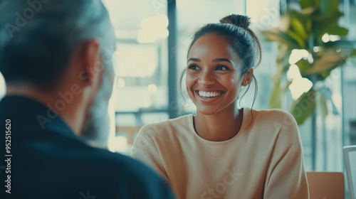 Fototapeta Naklejka Na Ścianę i Meble -  Happy middle aged business woman hr talking to recruit at job interview meeting. Smiling mature female financial advisor, professional bank manager consulting client working in corporate office