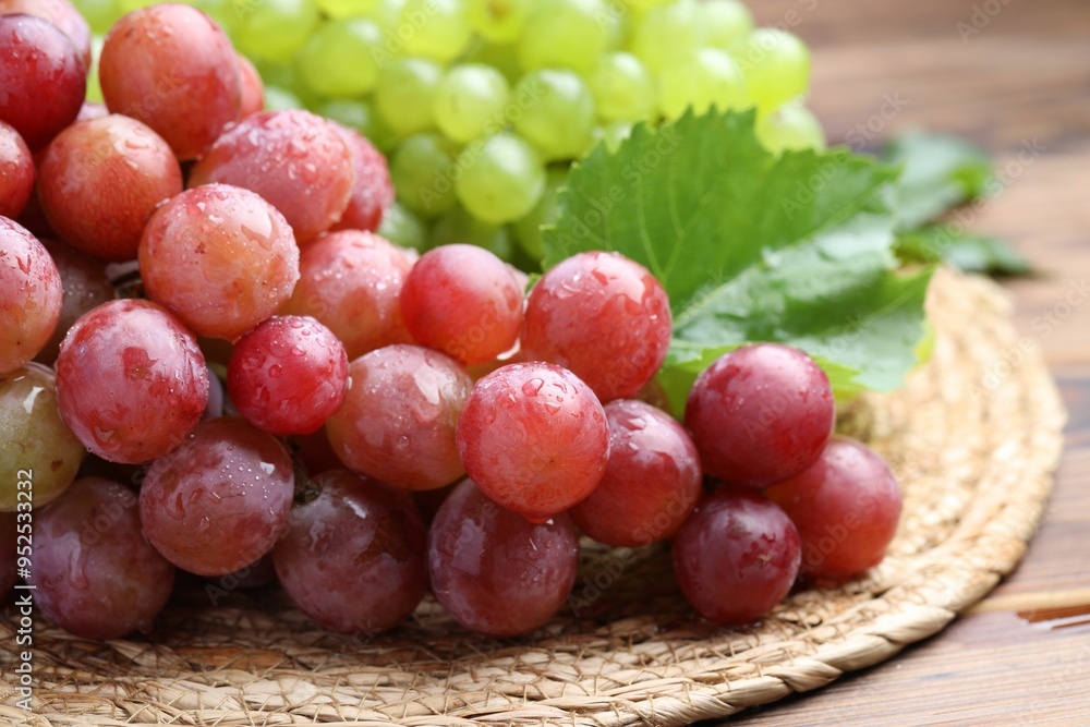 Fresh ripe grapes on wooden table, closeup Fresh ripe grapes on wooden table, closeup