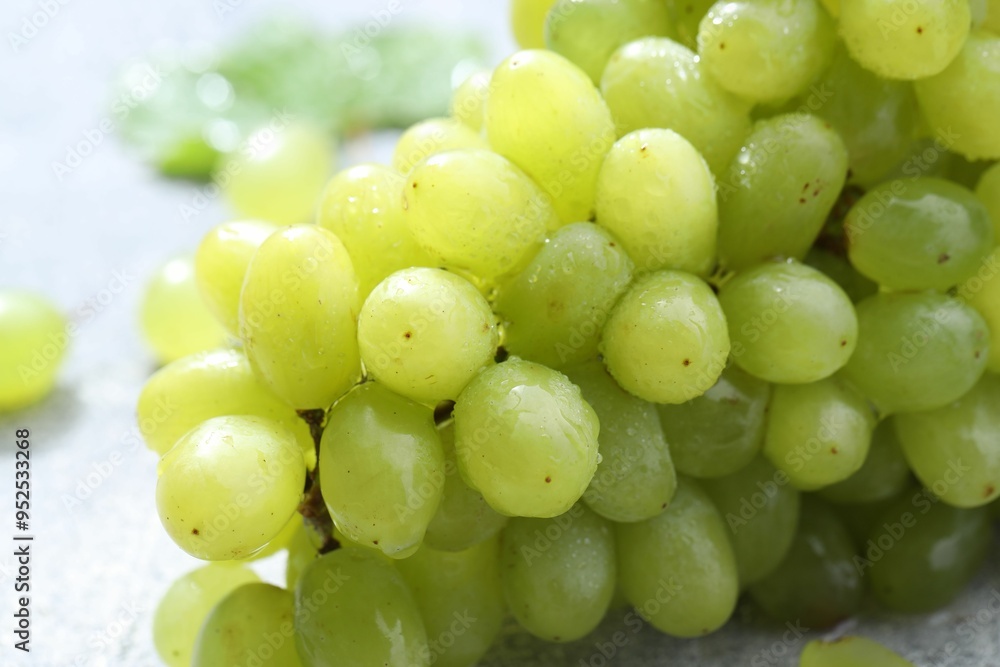 Fresh ripe grapes on grey table, closeup Fresh ripe grapes on grey table, closeup