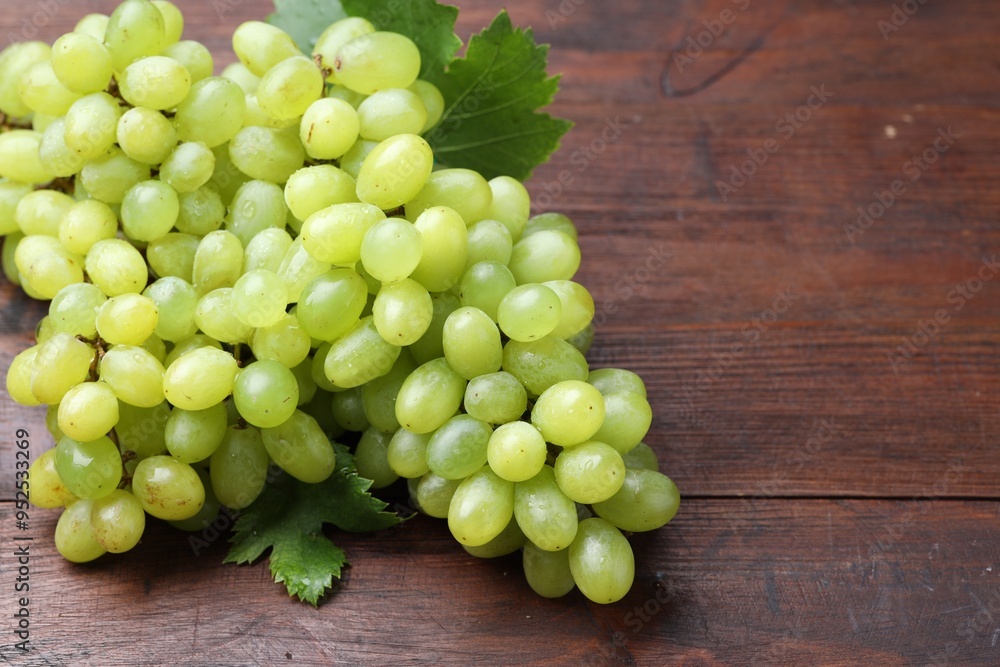 Fresh ripe grapes on wooden table, closeup Fresh ripe grapes on wooden table, closeup