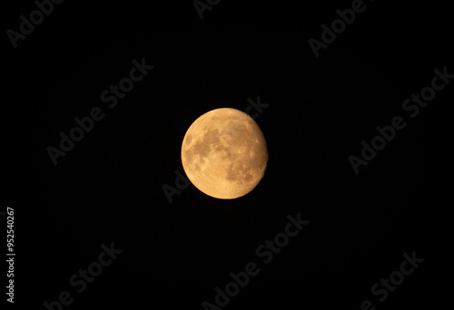 Full moon in the black sky, view from earth.