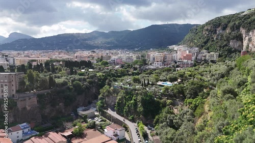 Cinematic footage of drone approaching towards residential buildings of Sorrento city against mountains, Campania, Italy