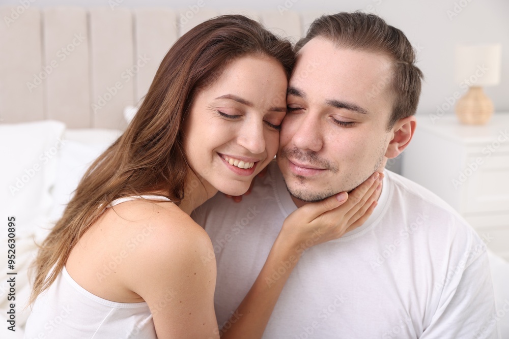 Happy couple spending time together on bed at home Happy couple spending time together on bed at home