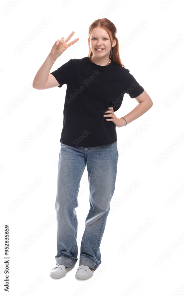 Fototapeta premium Teenage girl showing v-sign on white background