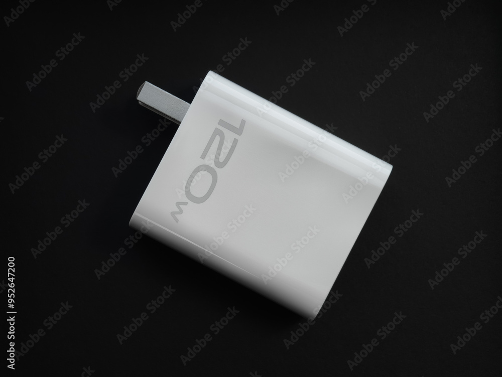 A phone charger on a black background
A phone charger on a black background