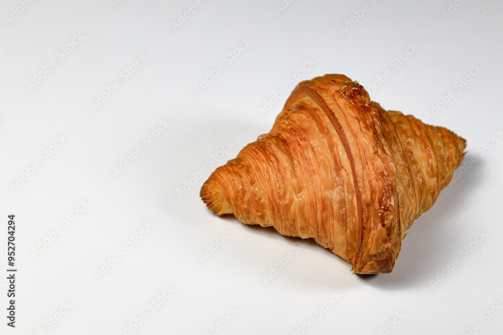 Freshly baked croissant, Brown crispy croissants isolated on white background. French pastry closeup photo. Buttered bread croissant isolated on white background. Freshly baked croissant, Brown crispy croissants isolated on white background. French pastry closeup photo. Buttered bread croissant isolated on white background.