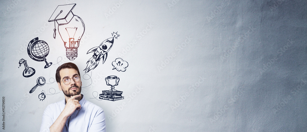 Man with hand on chin looking at education-related sketches on wall background. Man with hand on chin looking at education-related sketches on wall background.