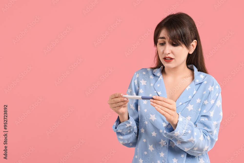 Worried young woman with pregnancy test on pink background, space for text Worried young woman with pregnancy test on pink background, space for text