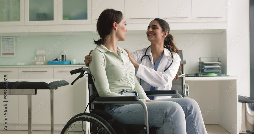 Woman with disability visit rehabilitation center, lead pleasant friendly conversation with young Indian nurse, receive professional medical services in private clinic. Medicine, health-care, check-up Woman with disability visit rehabilitation center, lead pleasant friendly conversation with young Indian nurse, receive professional medical services in private clinic. Medicine, health-care, check-up